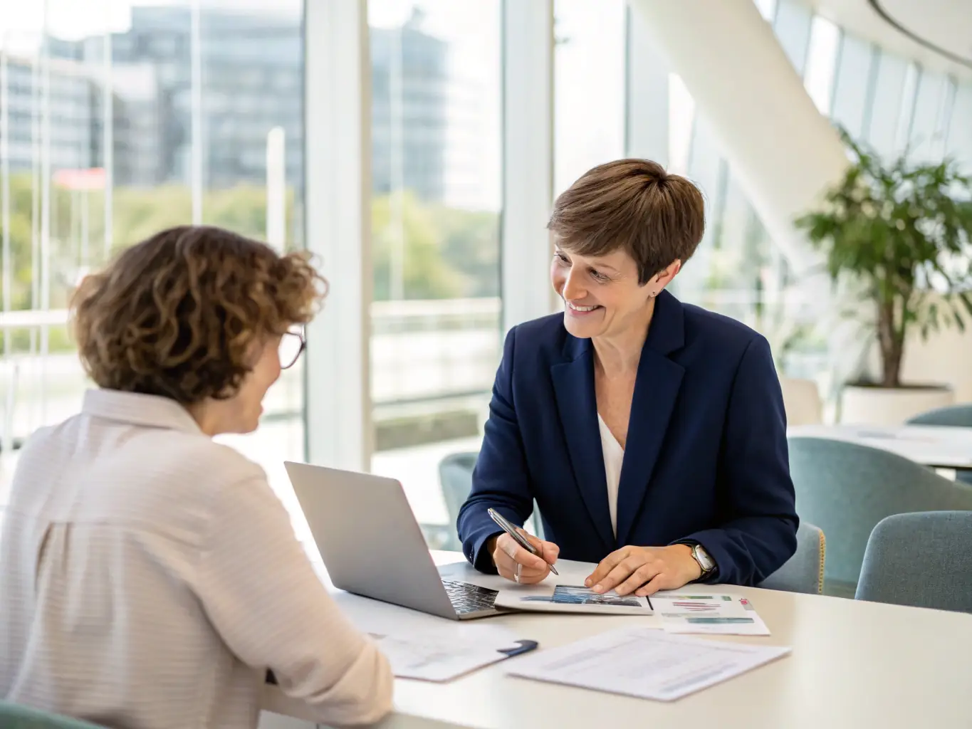 A friendly Little Home Loans advisor discussing loan options with a client in a modern office setting, emphasizing personalized service.