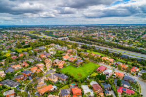 Aerial view of an Australian suburb showing house blocks and a vacant lot
