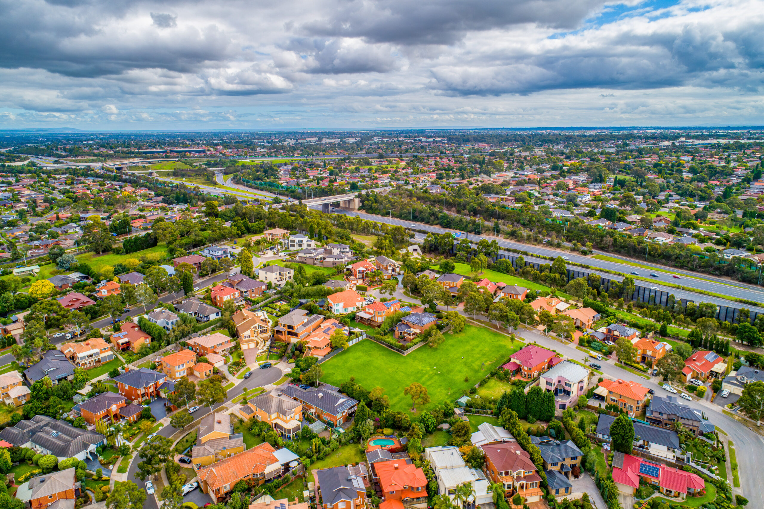 Aerial view of an Australian suburb showing house blocks and a vacant lot
